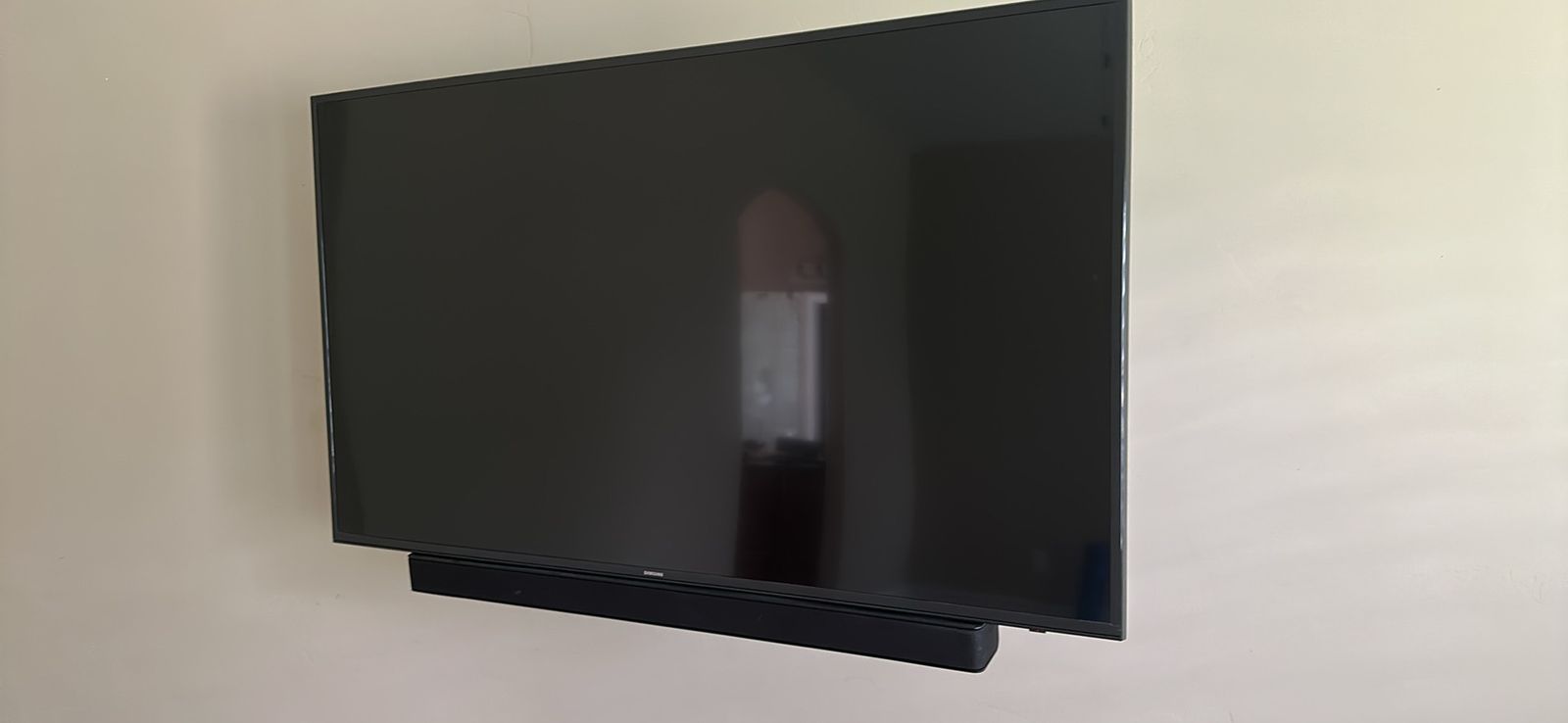 Samsung 55-inch 4K Smart TV with Vizio Soundbar and heavy duty wall mount.
