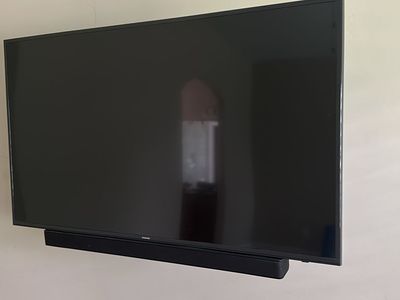 Samsung 55-inch 4K Smart TV with Vizio Soundbar and heavy duty wall mount.