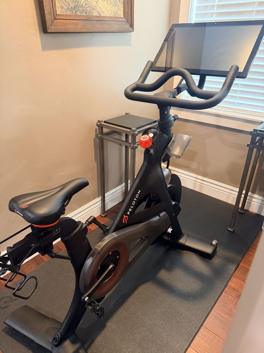Peloton Indoor Exercise Bike with Touchscreen Display and Floor Mat