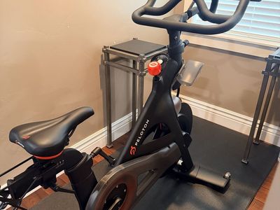Peloton Indoor Exercise Bike with Touchscreen Display and Floor Mat