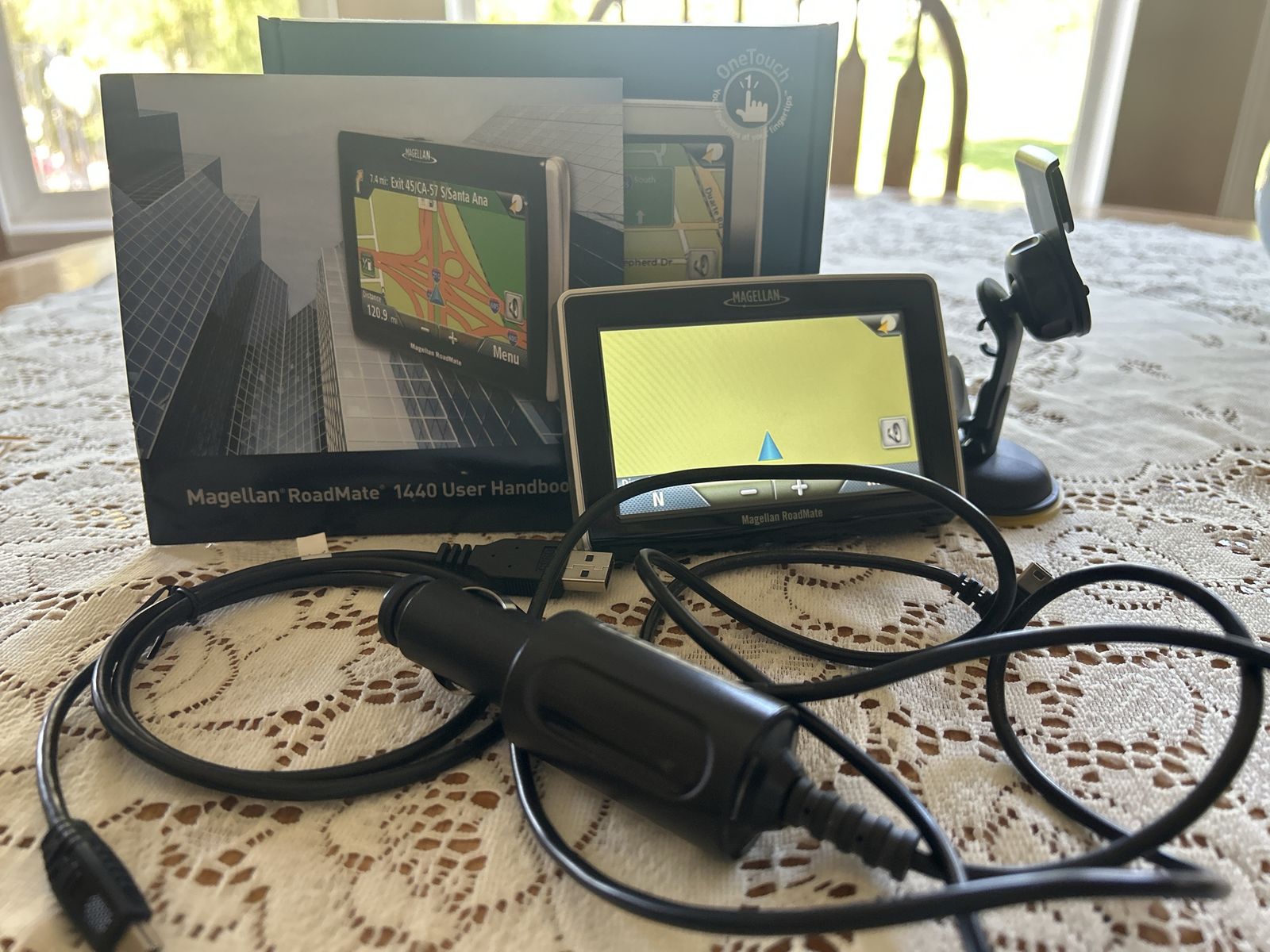 Magellan RoadMate 1440 GPS Navigator with Mount, Car Charger, and Manual