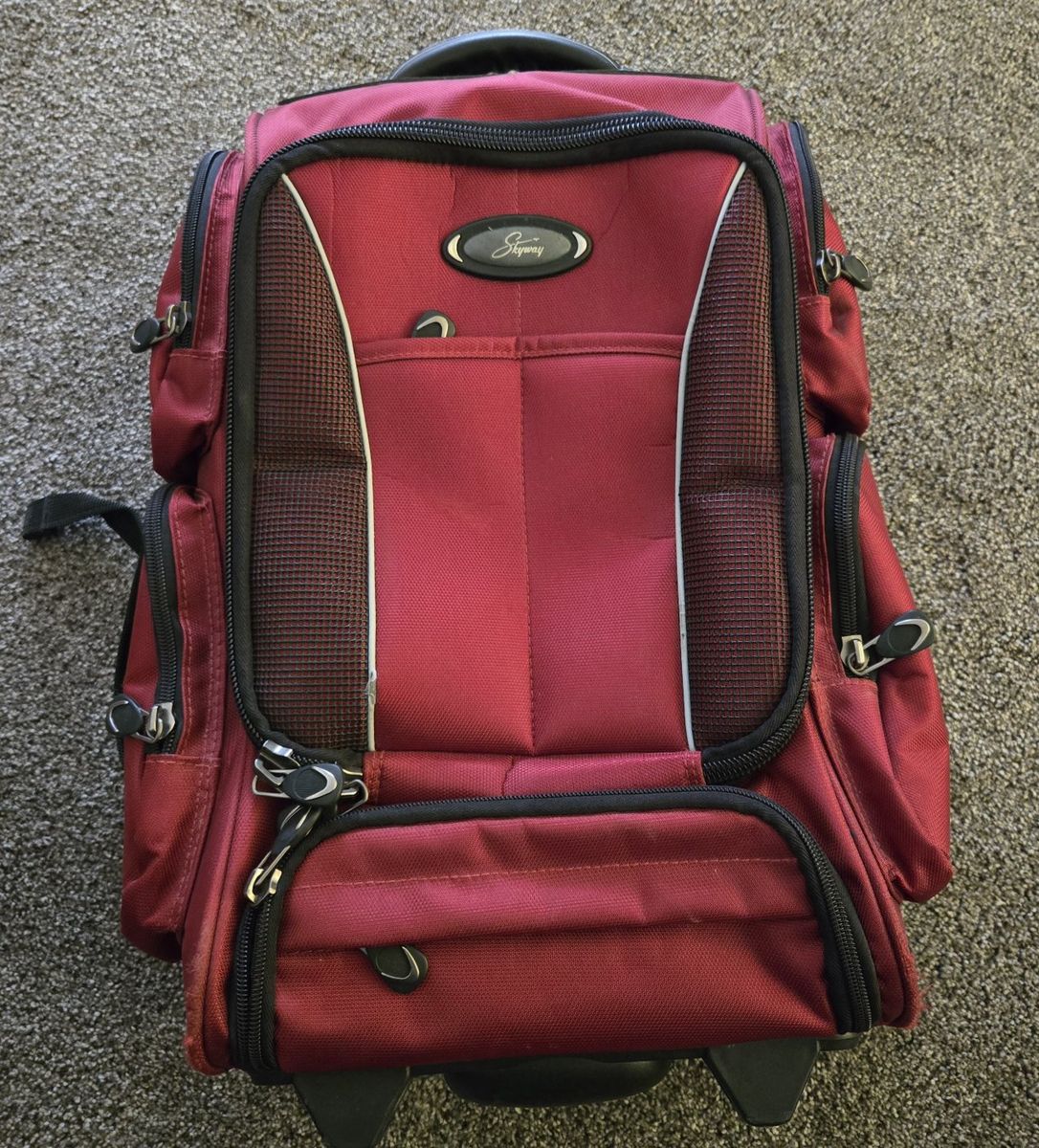 Skyway Red Rolling Backpack Luggage - Versatile Travel Bag with Retractable Handle