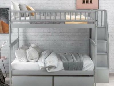Full over full bunk bed with stairs, shelves, and two large drawers
