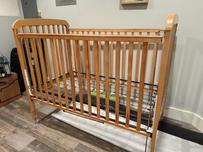 Natural Wood tone Portable Crib with Casters
