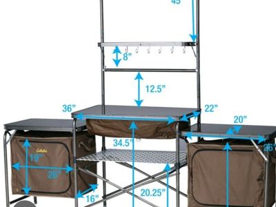 Cabela's Deluxe Camper's Camping Camp Kitchen Portable Outdoor Cooking Station
with Sink, Organization Storage Shelves, and bag.