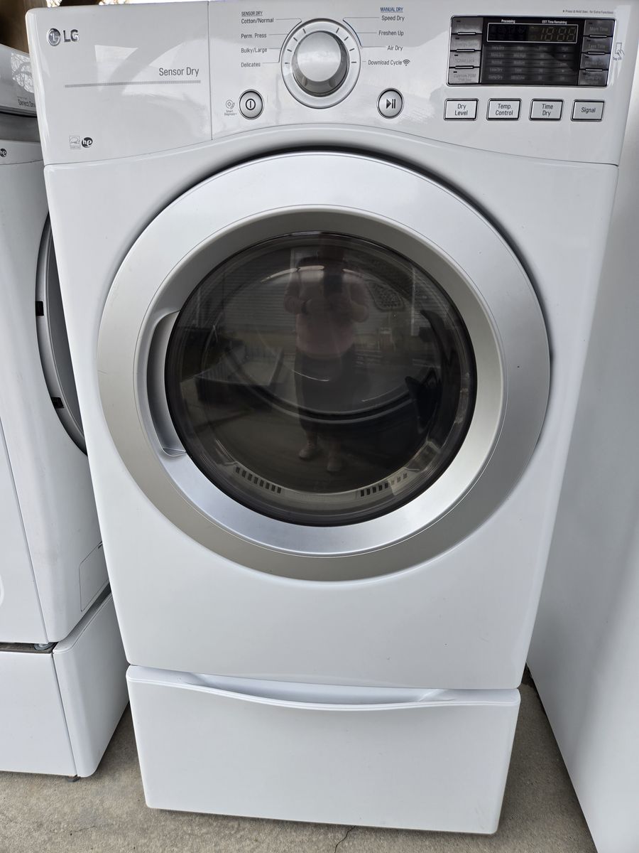 LG washer and dryer with pedestals and instruction manuals
