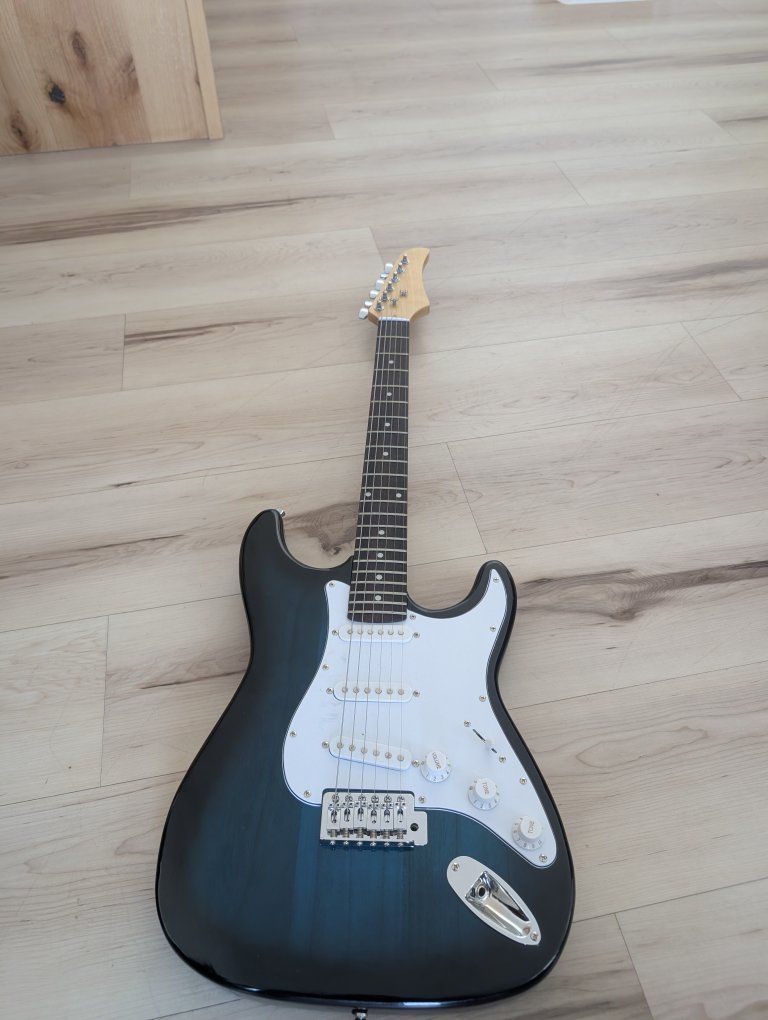 Electric guitar with bluish green White and tan