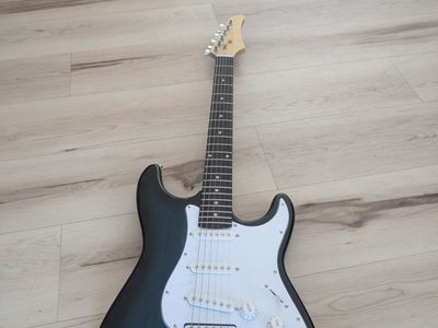 Electric guitar with bluish green White and tan