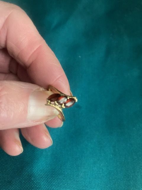 Ladies’ yellow metal stamped garnet ring.