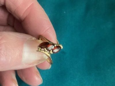 Ladies’ yellow metal stamped garnet ring.