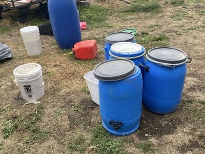 Assorted Blue Plastic Barrels and Storage Drums