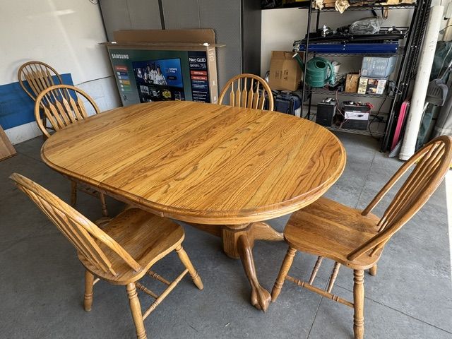Solid Oak Table with expansion leaf. 6 ft by 4 ft plus leaf. 4 Chairs