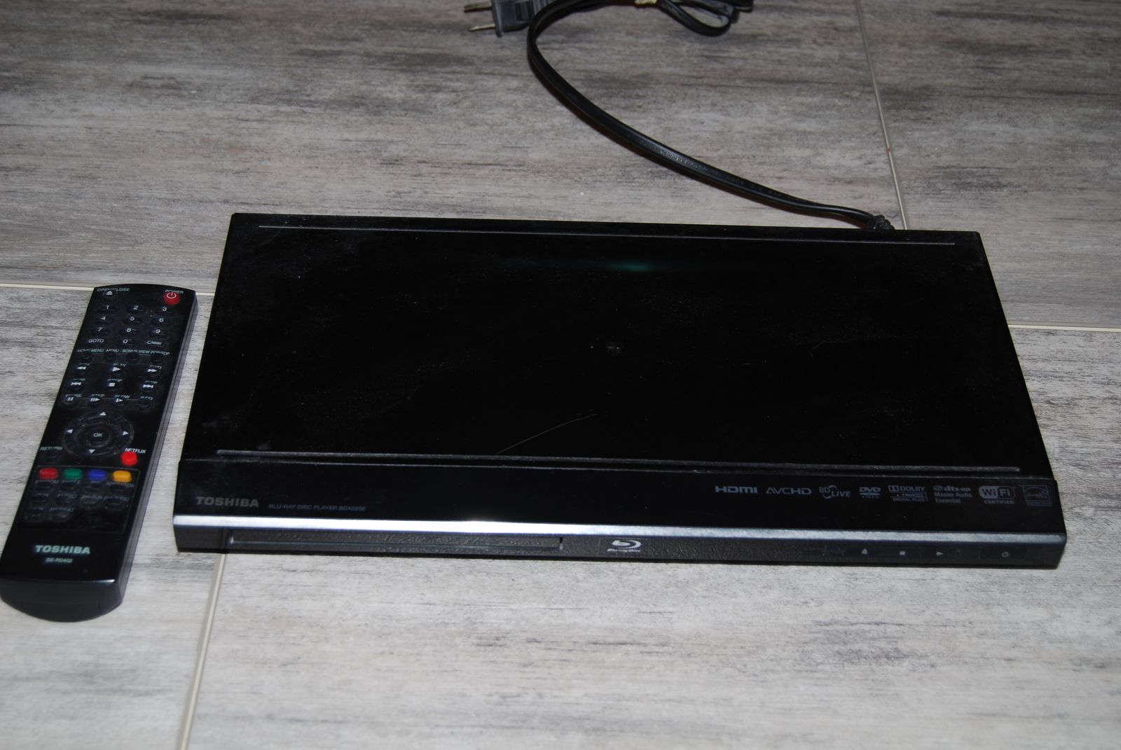 A Toshiba  brand DVD BluRay player with remote
