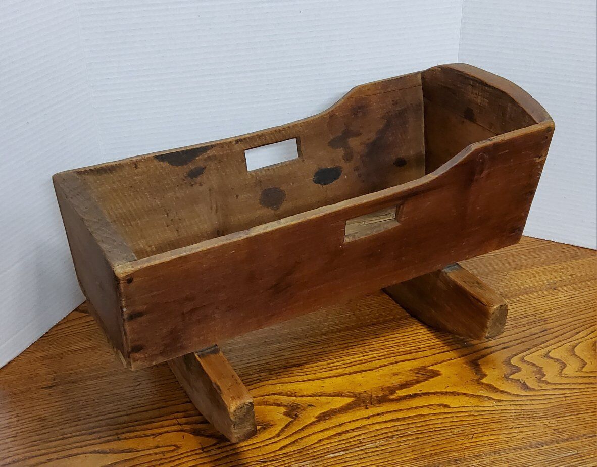This handmade oak doll cradle, dating back to 1930