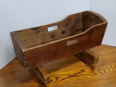 This handmade oak doll cradle, dating back to 1930