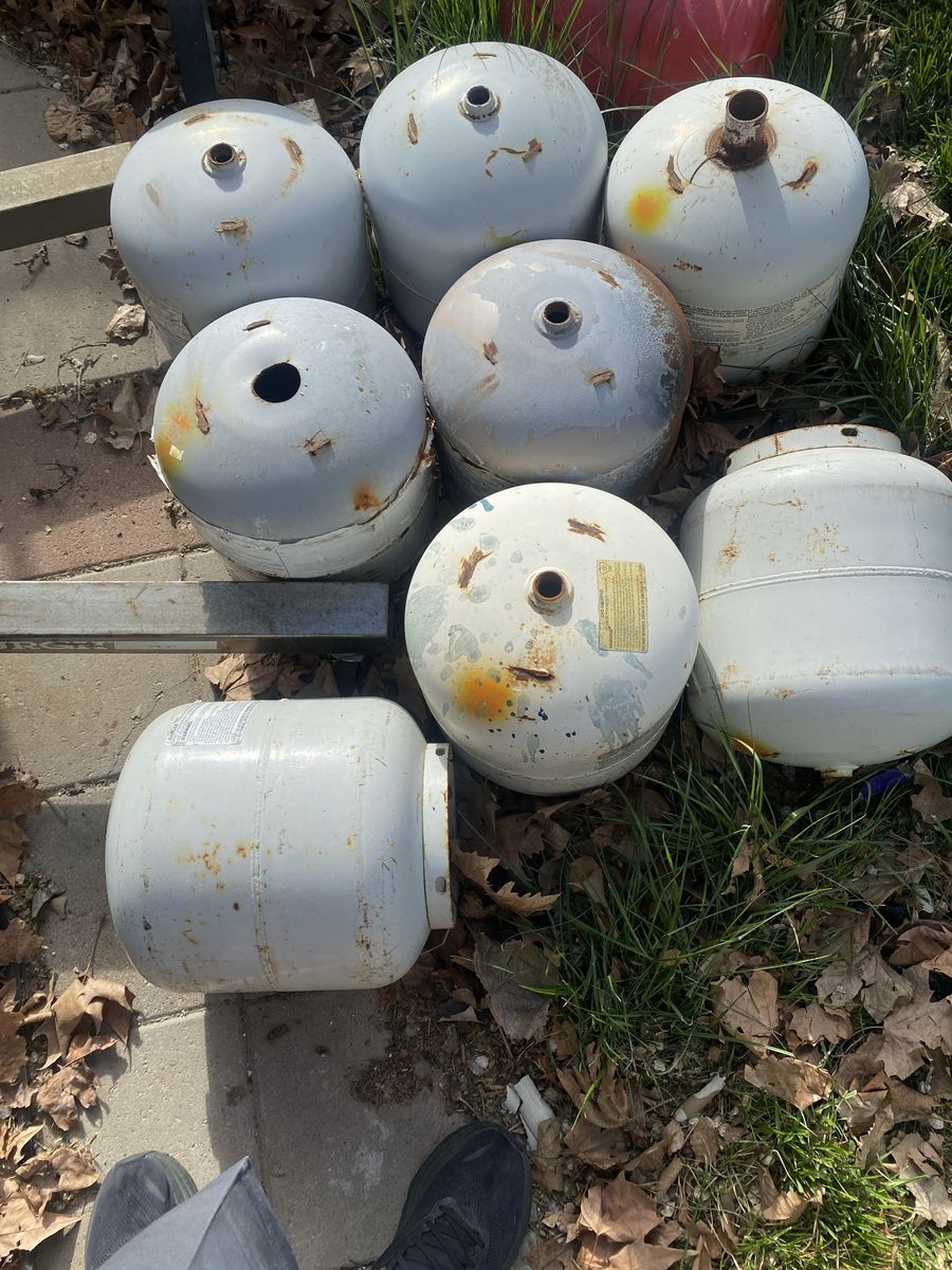 Eight propane tanks (with valves removed)