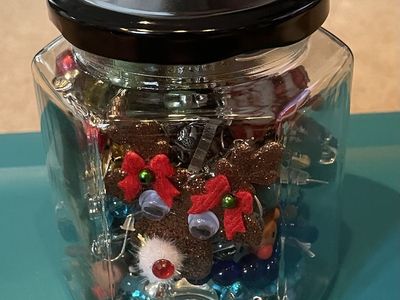 Glass Jar filled with Christmas themed Earrings. necklaces and Bracelets
