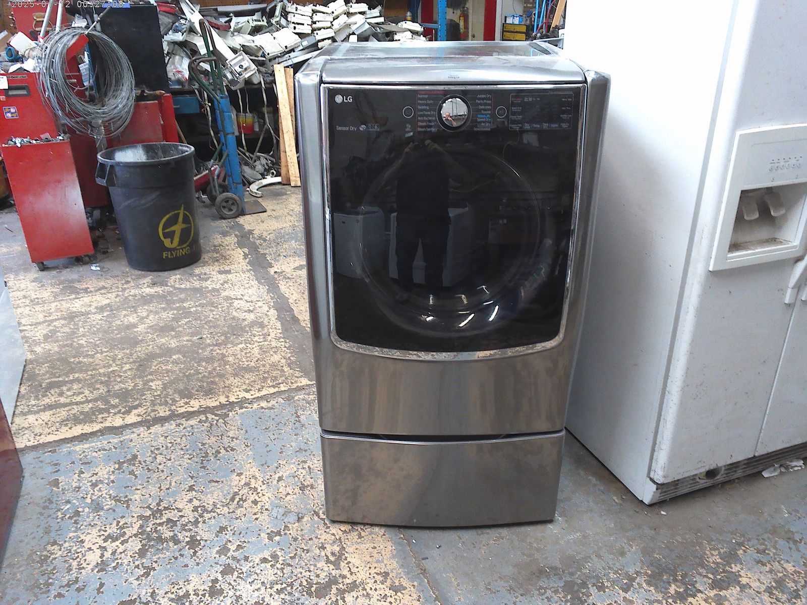 LG and Whirlpool front load electric dryers on pedestals