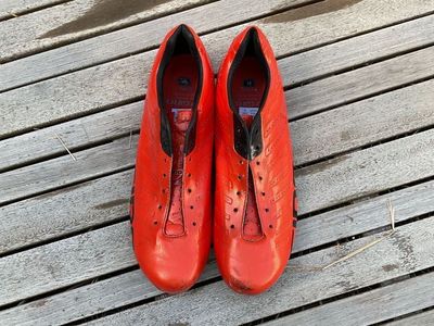 bright orange road biking shoes. No cleats or laces.