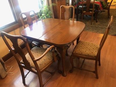 Oak dining table and 4 chairs with self storing leaf. $500