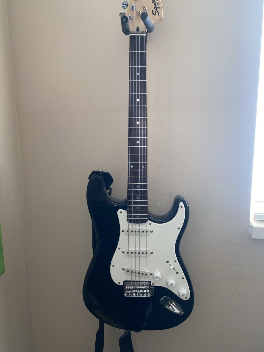 Squier Strat by Fender electric guitar with amp, cord and fx pedal