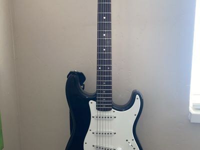 Squier Strat by Fender electric guitar with amp, cord and fx pedal