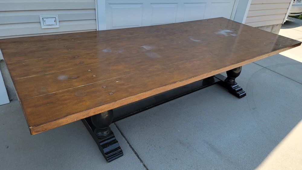10ftx4ft Rustic farmhouse-style trestle dining table with a dark brown wood top and black pedestal legs