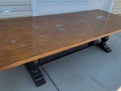 10ftx4ft Rustic farmhouse-style trestle dining table with a dark brown wood top and black pedestal legs