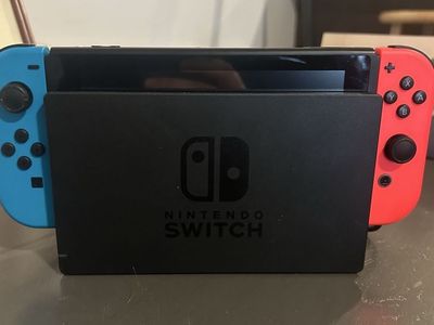 Nintendo switch console bundle w/dock, 2 joycons, carrying case, and charger cable.
