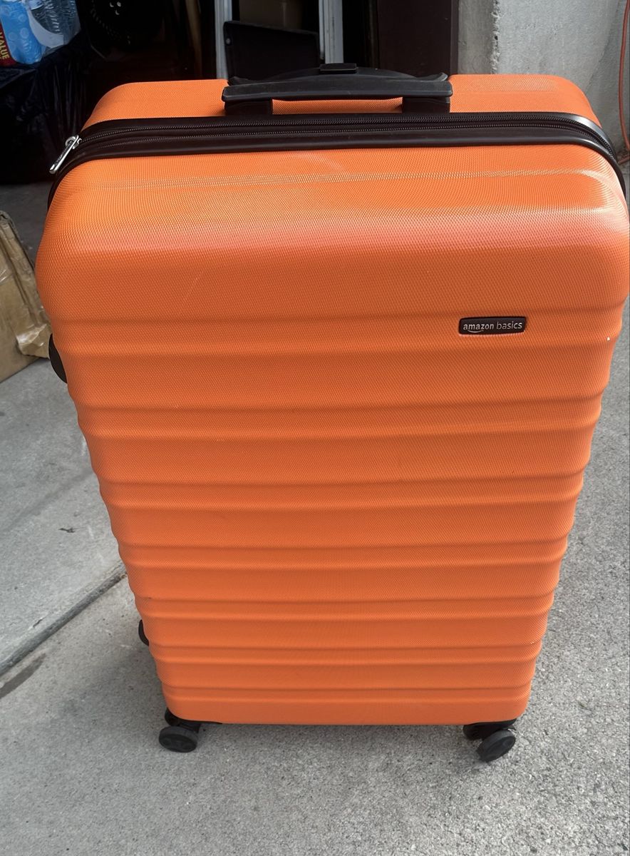 61” linear inches can be checked in on planes. Orange Hardside Spinner Luggage. Used like new