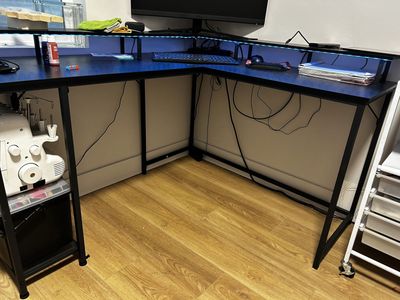 Corner desk with lights and outlets.