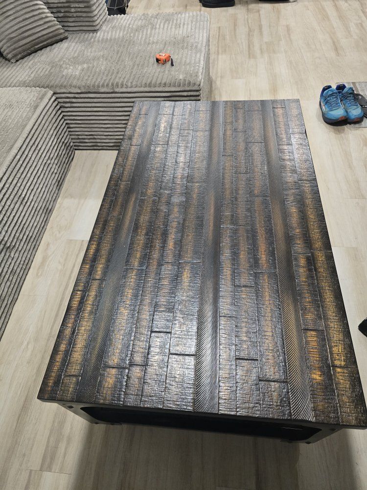 Rising coffee table on locking wheels