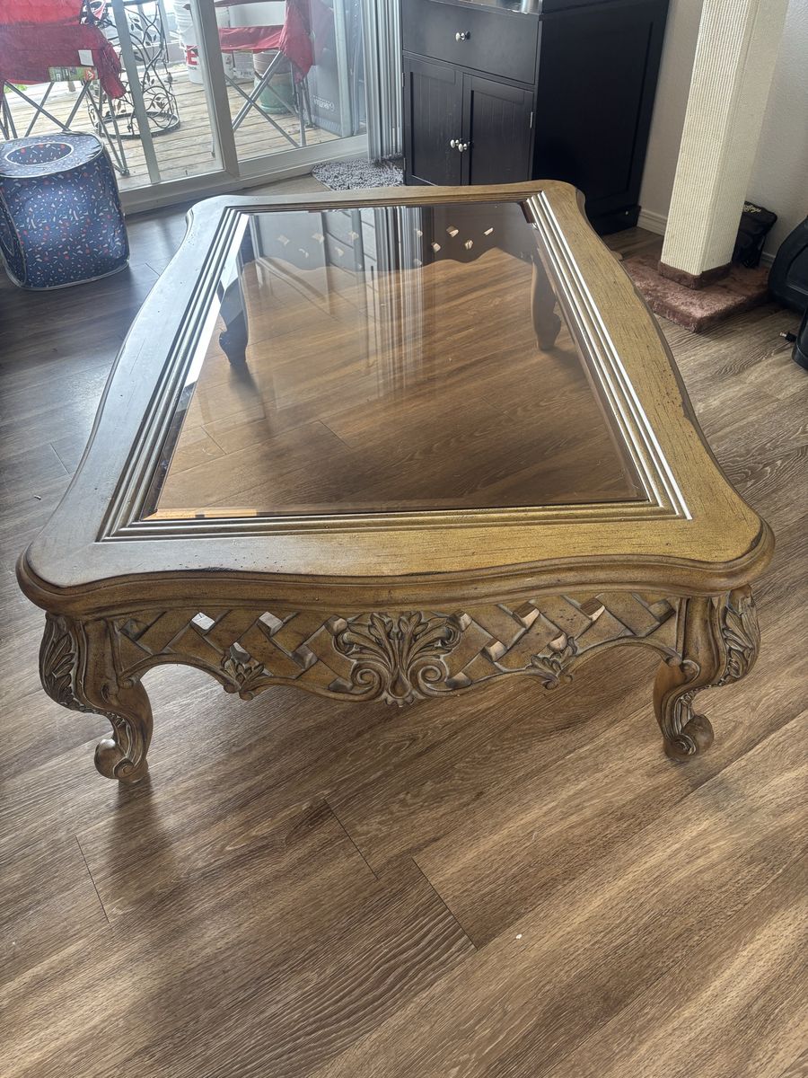 Ornate Wooden Coffee Table with Glass Top and Carved Details