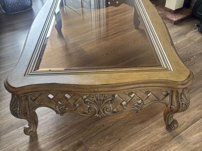 Ornate Wooden Coffee Table with Glass Top and Carved Details