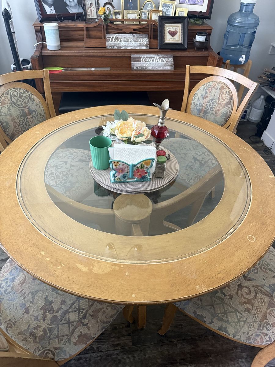 Wood Dinning room table with a glass top and 4 chairs.