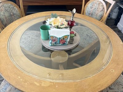 Wood Dinning room table with a glass top and 4 chairs.