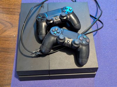 PS4 with 2 controllers and power cord