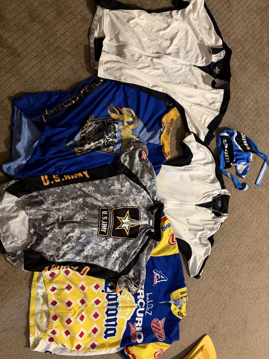 Lot of 5 and more Cycling Jerseys: US Army, Corona, SRAM & More - Assorted Sizes & Styles ranging from Medium to mostly large.