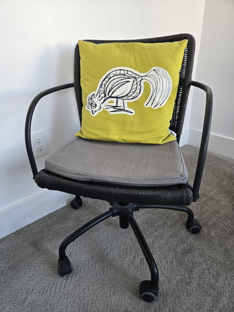Wicker Rolling Office Chair with Grey Cushion and Yellow Pillow