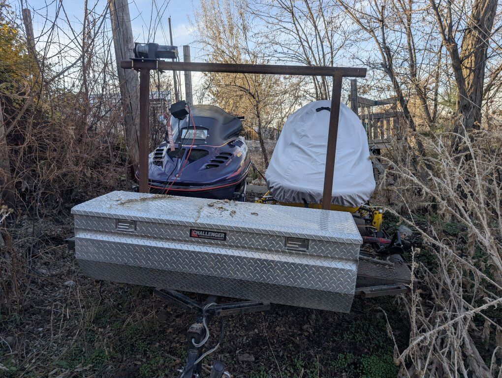 2 snowmobiles and trailer