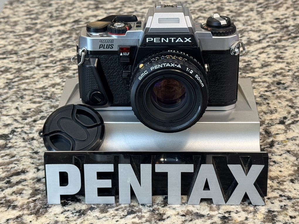 Pentax Program Plus 35mm film camera SLR with 50mm prime lens.