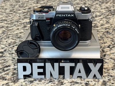 Pentax Program Plus 35mm film camera SLR with 50mm prime lens.