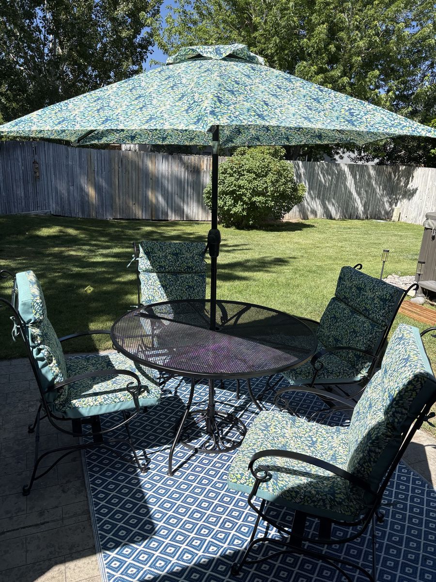 Gorgeous Wrought Iron Patio Table and Rocking Chairs with Cushions and Matching Umbrella
