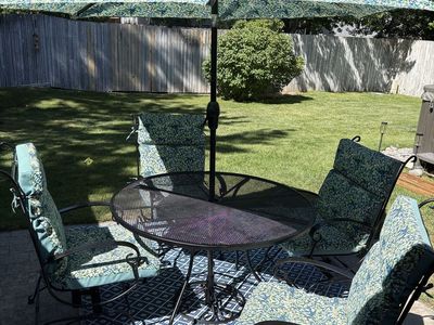 Gorgeous Wrought Iron Patio Table and Rocking Chairs with Cushions and Matching Umbrella