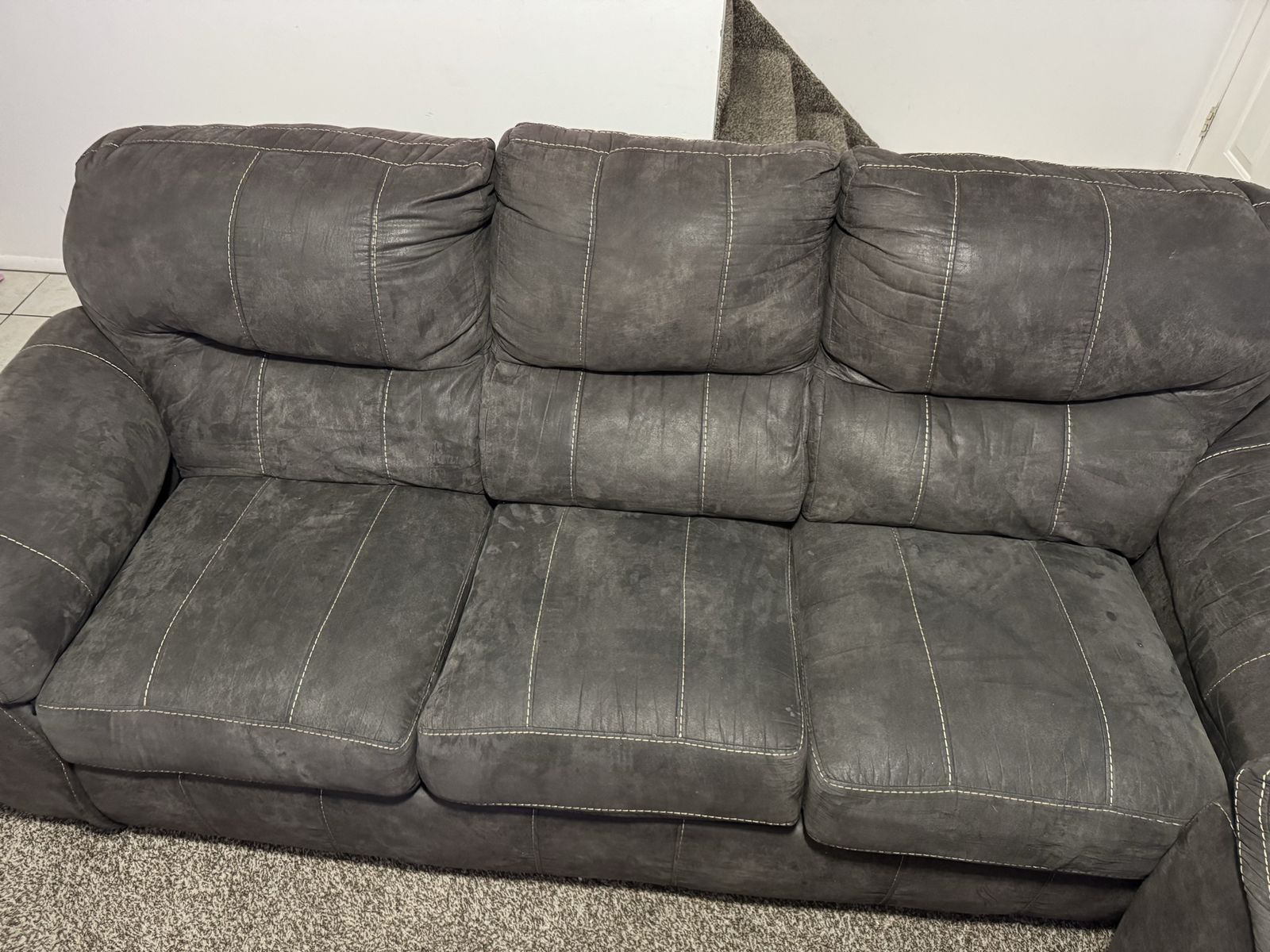 Gray Upholstered Sofa and Loveseat Set with White Stitching