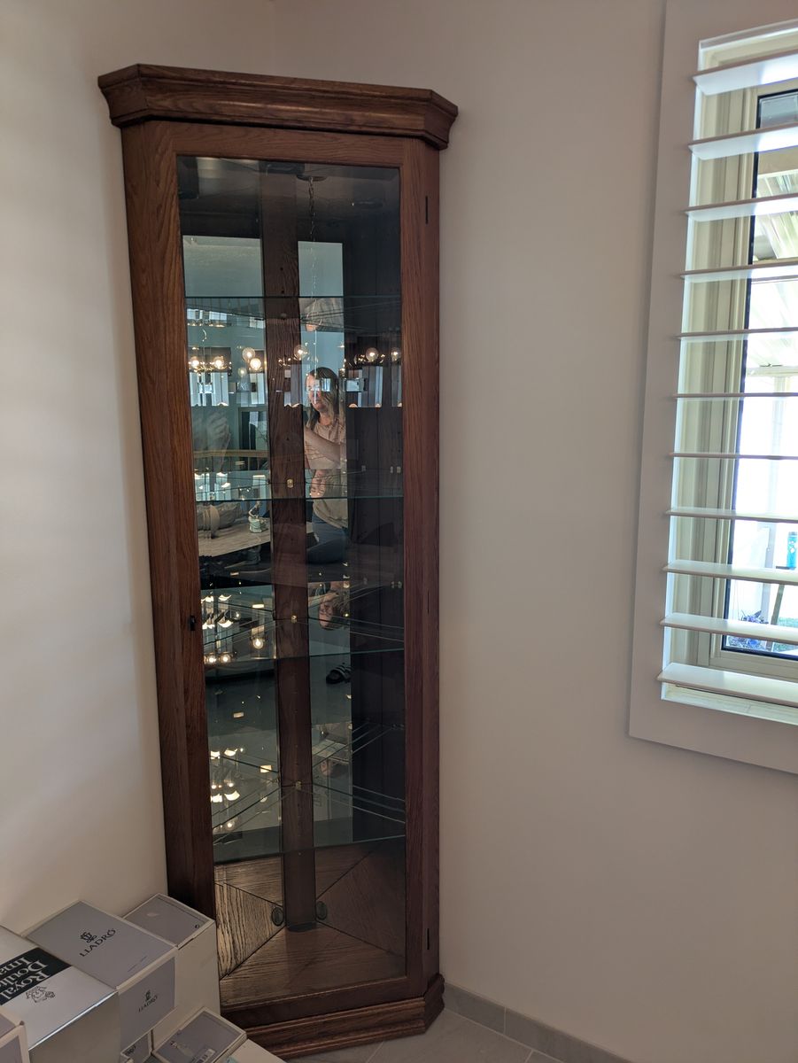 Two corner curio cabinets