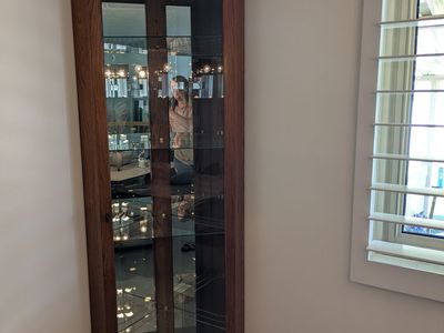Two corner curio cabinets
