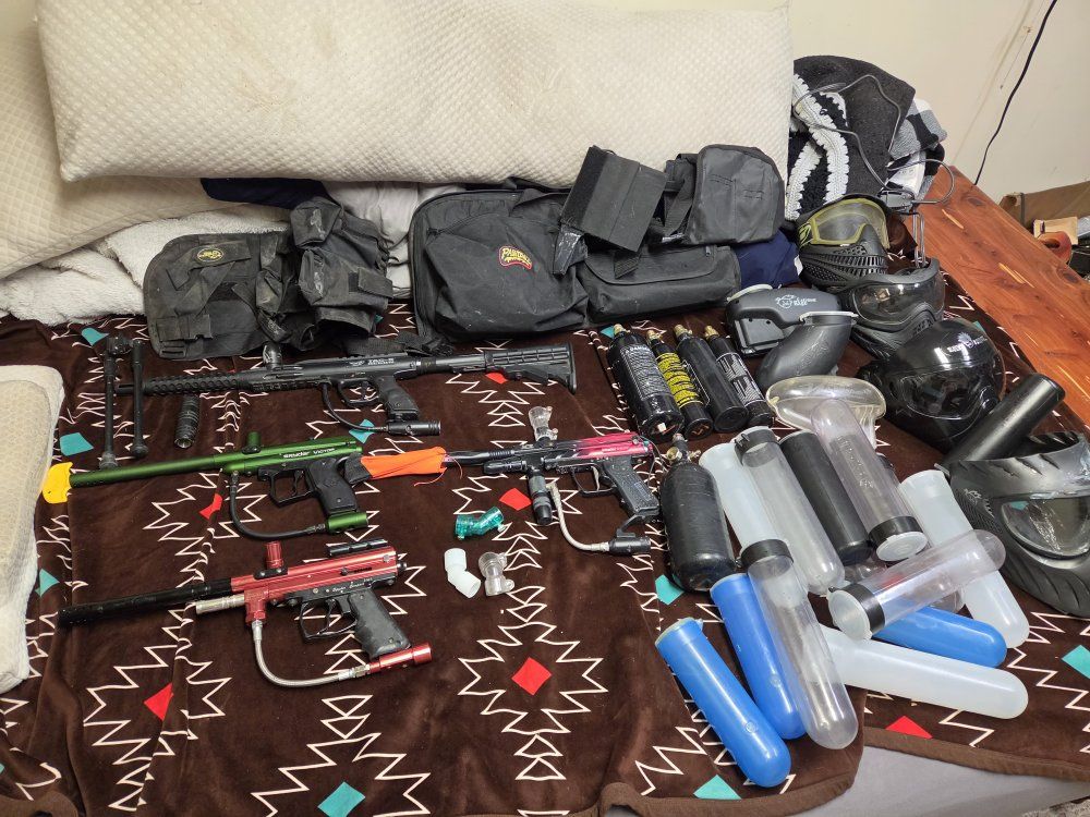 bunch of paintball guns and gear