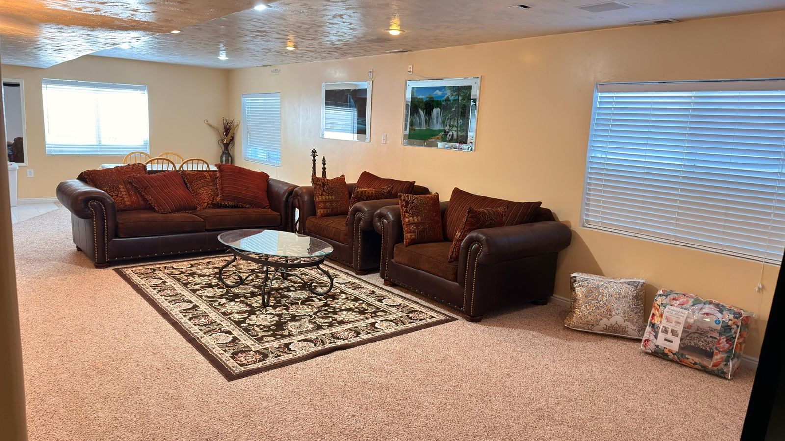 Luxurious Brown Leather Sofa and Loveseat Set with Nailhead Trim and Decorative Pillows