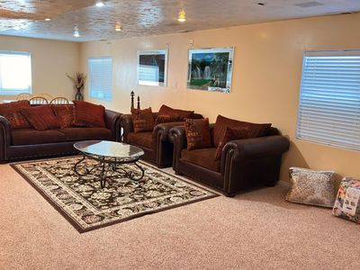 Luxurious Brown Leather Sofa and Loveseat Set with Nailhead Trim and Decorative Pillows
